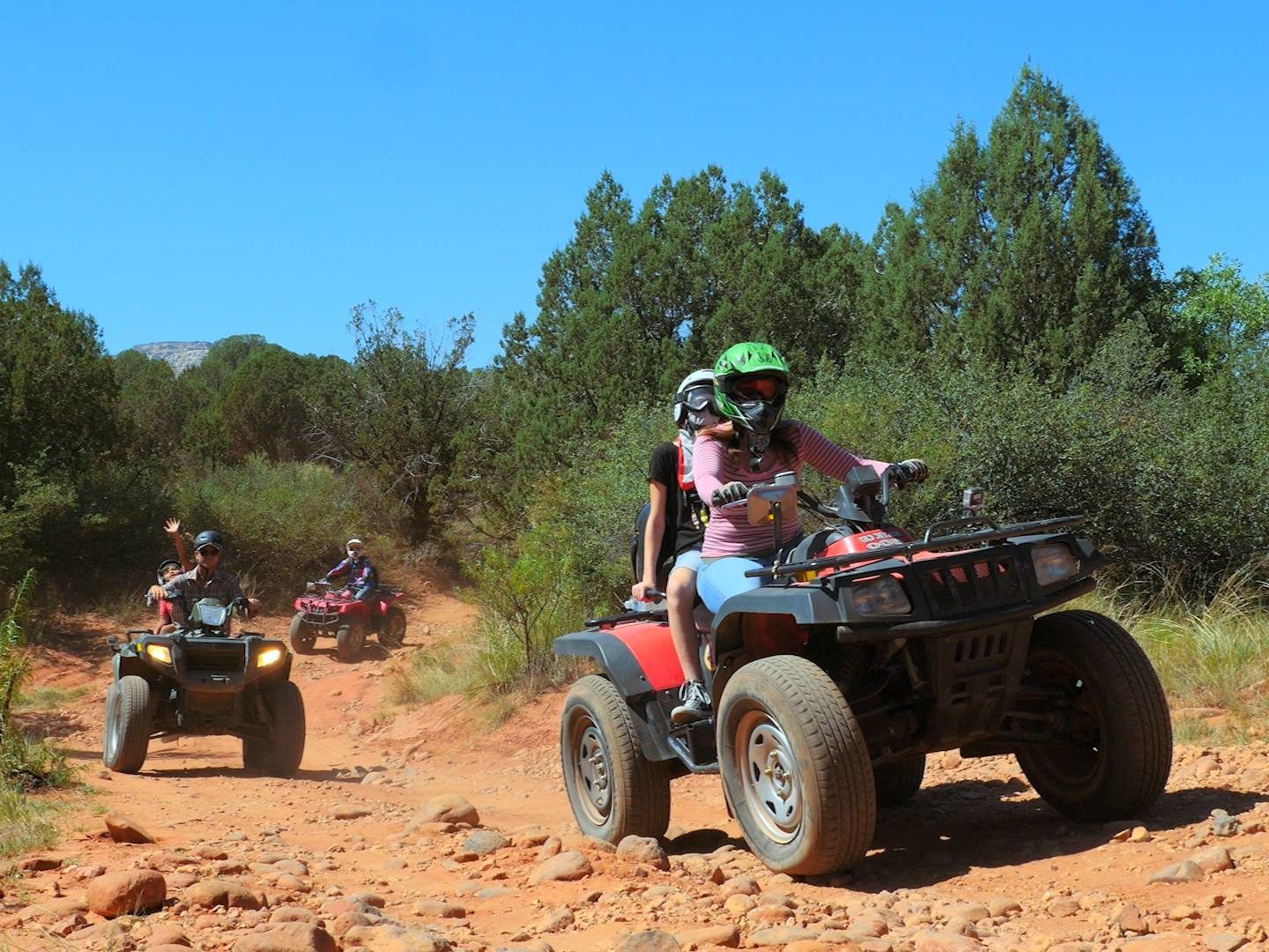a person riding an ATV down a dirt trail in Arizona