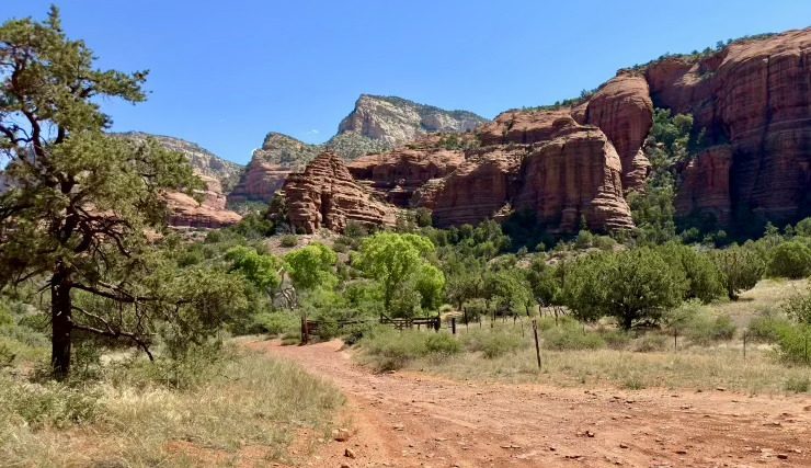 A stunning red rock formation of Sedona, Arizona, with towering canyon walls and vibrant blue skies, showcasing the natural beauty and adventurous spirit of the landscape.